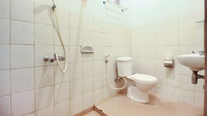 A small, clean bathroom with a toilet, sink, and shower. - RedDoorz Syariah near Wijilan Yogyakarta (Yogyakarta)
