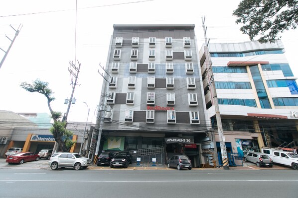 A multi-story building with a storefront labeled "RedDoorz" and "Apartment 20" below. - RedDoorz Plus @ Kamuning Quezon City (Quezon City)