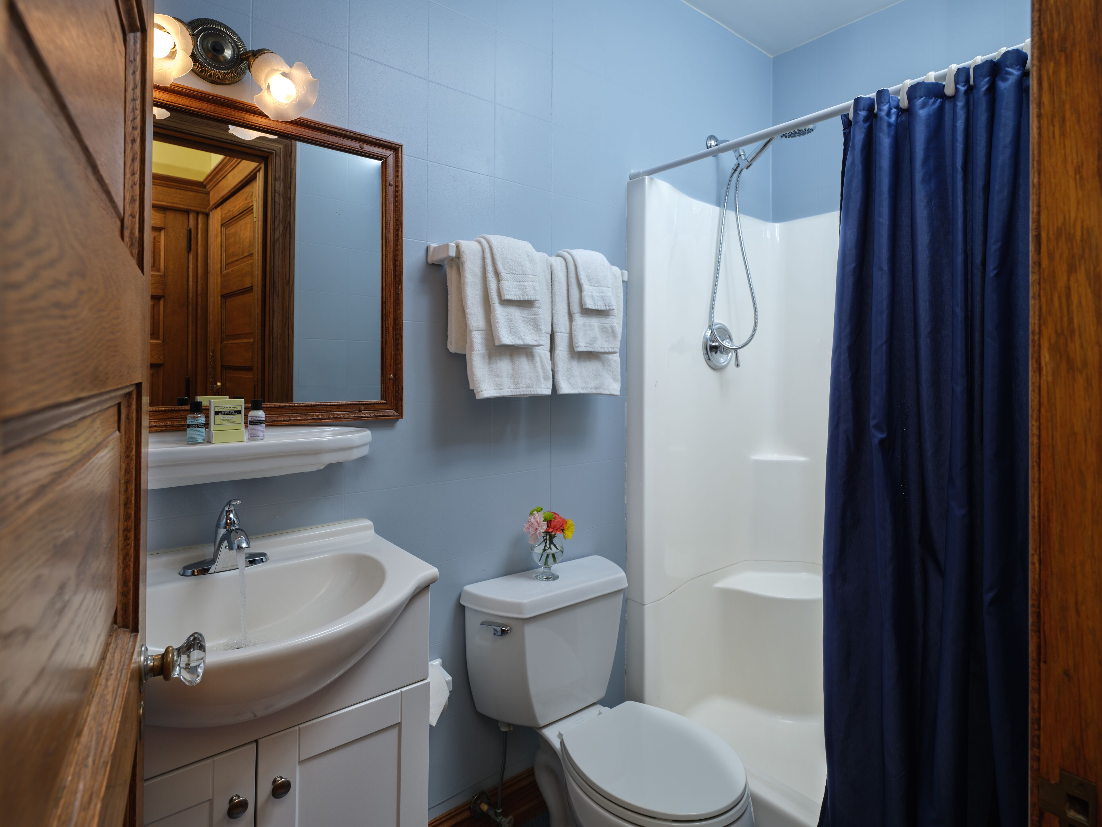 A bathroom with a sink, toilet, and shower.