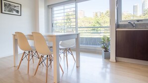 A modern kitchen with a large window, a dining area with a table and chairs, and a potted plant. - Las Heras by Be Local Argentina (Buenos Aires)