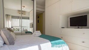 A bedroom with a bed, a TV, and a wardrobe. - Las Heras by Be Local Argentina (Buenos Aires)
