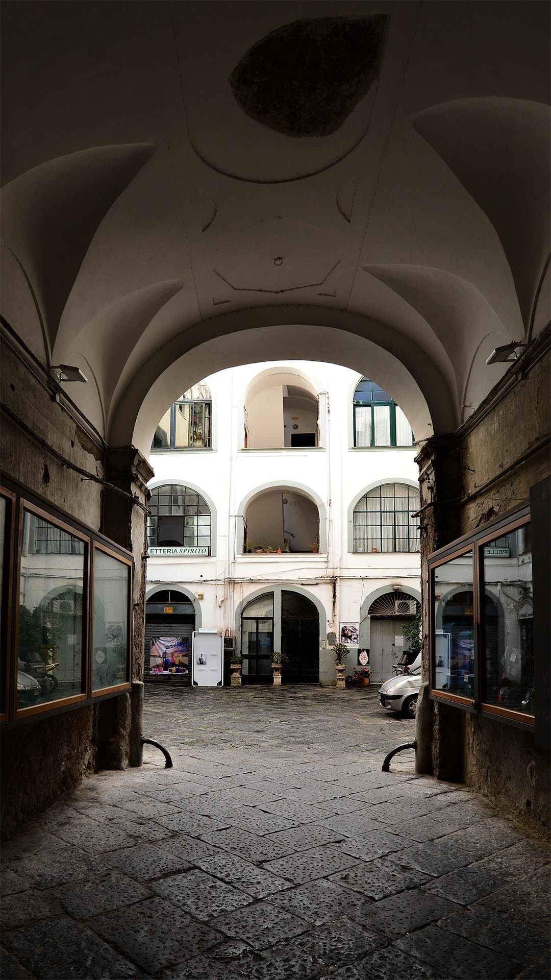 An interior courtyard with arched ceilings and a central open space.