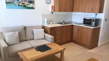 Suite, Sea View | Living area | Flat-screen TV