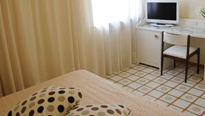 A bedroom with a bed, a desk with a computer, and a chair. - Via Capo Rooms (Sorrento)