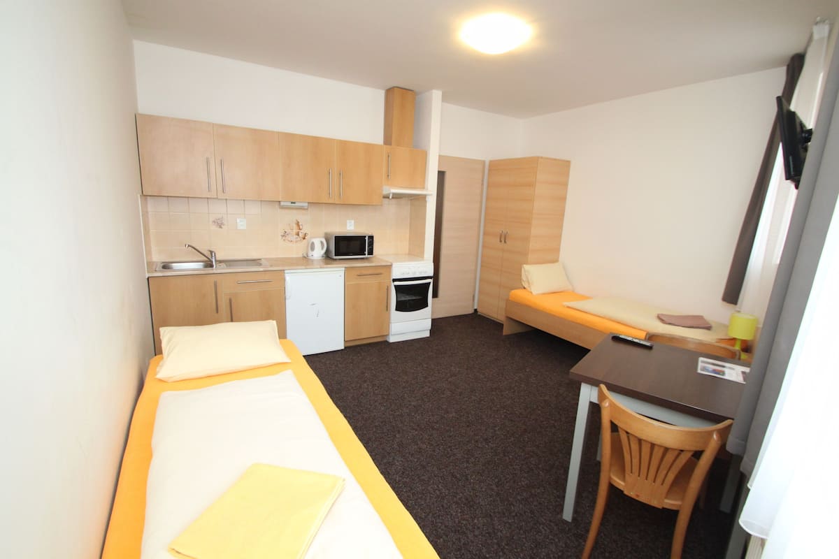 full-sized fridge, microwave, stovetop, electric kettle