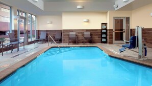 An indoor swimming pool with clear water, surrounded by lounge chairs and a changing room. - Fairfield Inn & Suites by Marriott Denver Tech Center North (Denver)