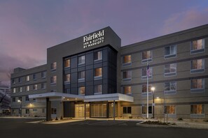 A Fairfield Inn & Suites by Marriott hotel with a modern design, multiple floors, and a covered entrance.