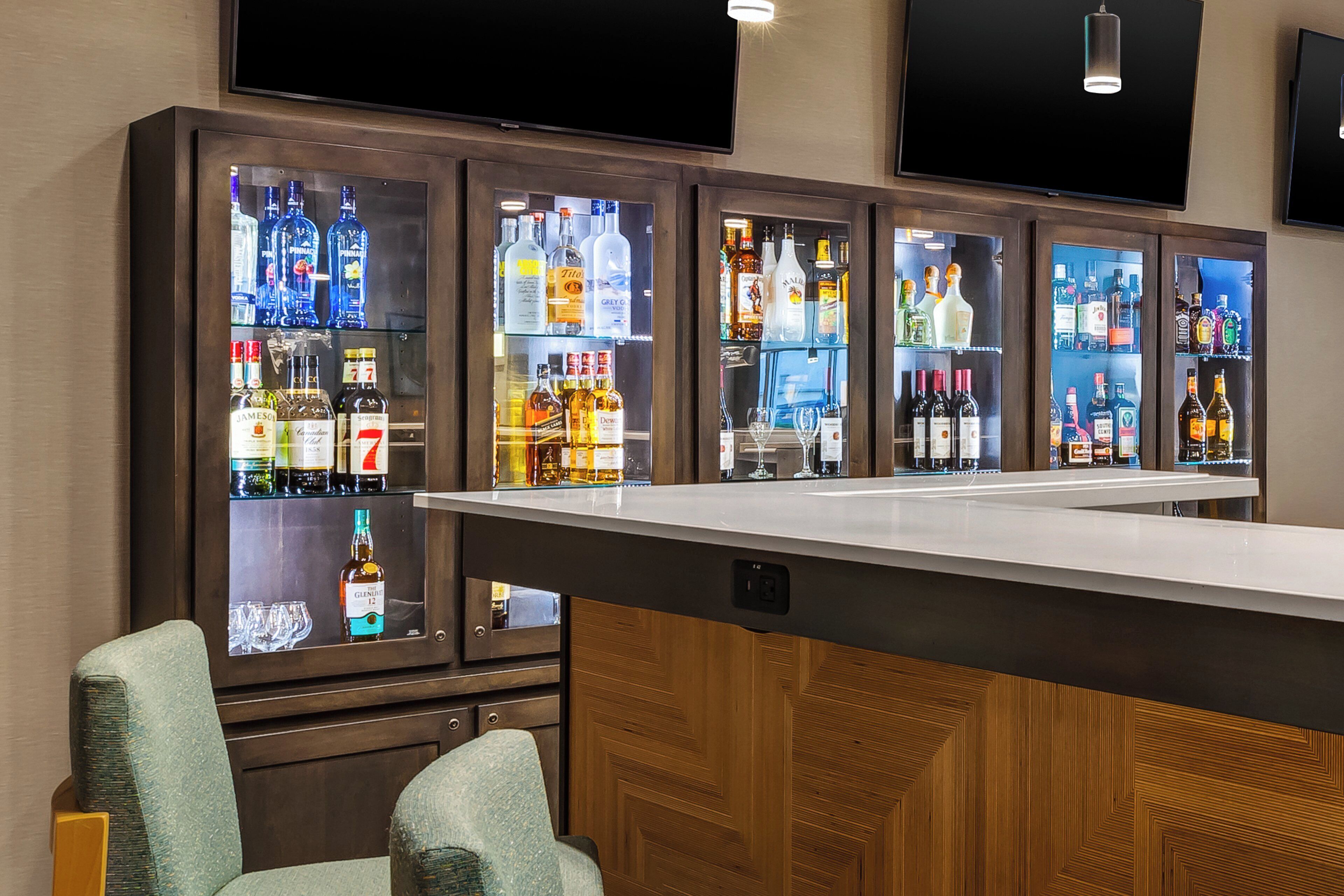 A bar area with multiple liquor cabinets and a bar counter.
