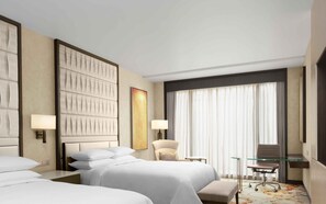A hotel room with two beds, a chair, a desk, and a large window with curtains. - Sheraton Manila Hotel at Newport World Resorts (Pasay)