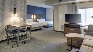 A hotel room with a bed, a desk with chairs, a TV, a sofa, and a small table. - Residence Inn by Marriott Fort Lauderdale Coconut Creek (Coconut Creek)