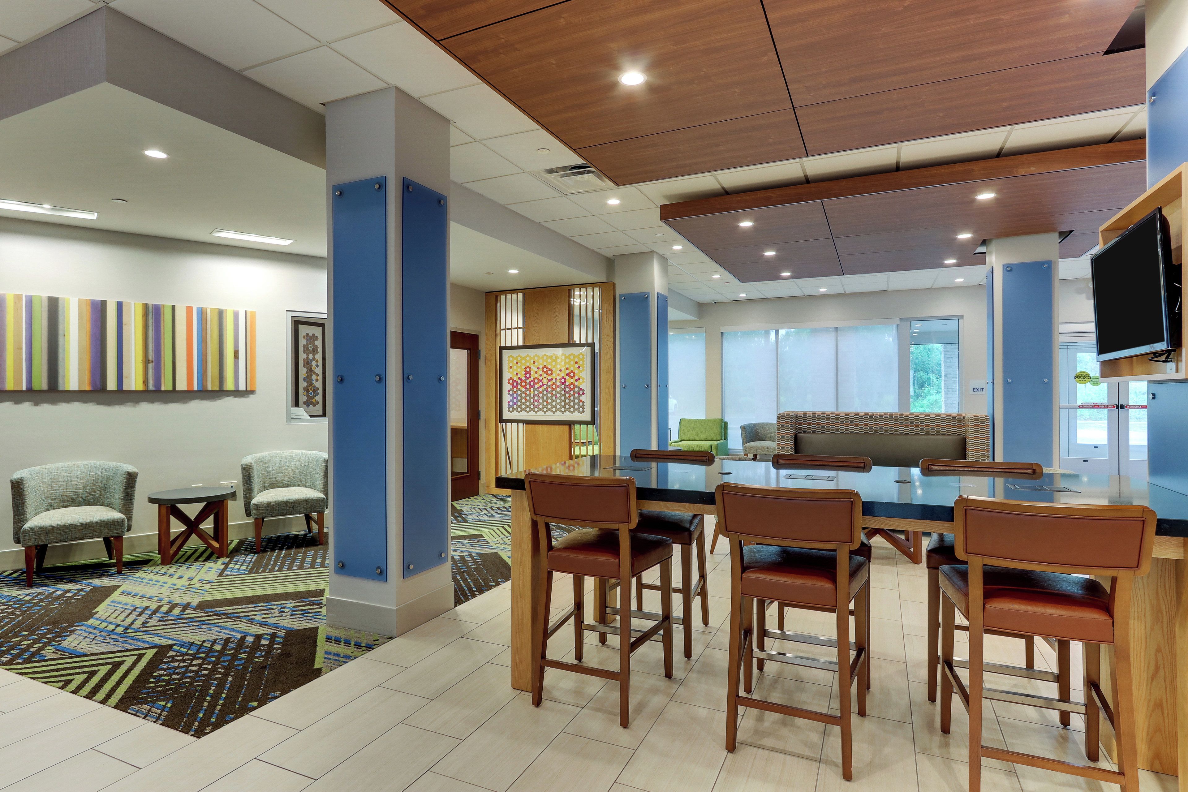 A modern interior with a bar area, seating, and artwork on the walls.