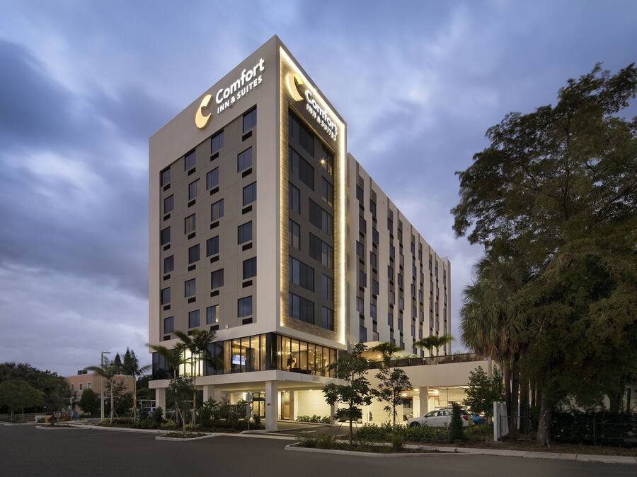 A tall hotel with a prominent sign reading "Comfort Inn & Suites."