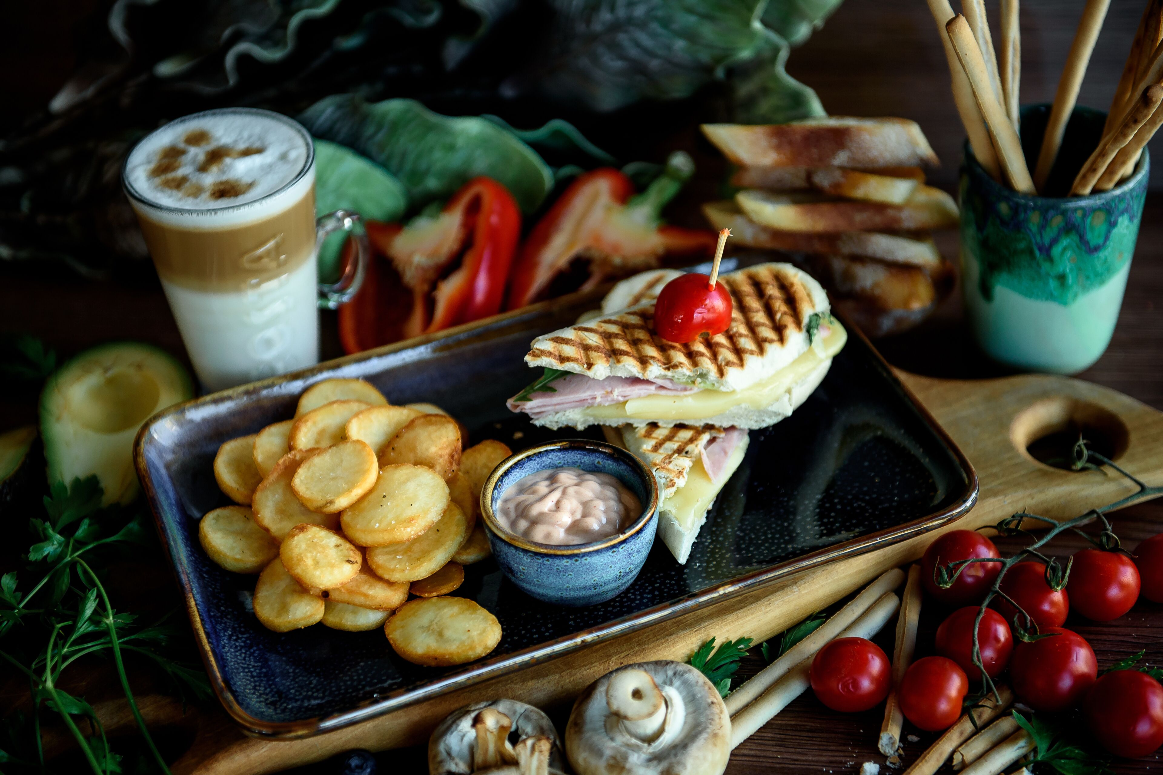 A tray with a sandwich, chips, and a drink.