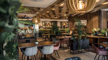 A modern cafe with wooden accents, a variety of seating options, and a well-stocked counter.