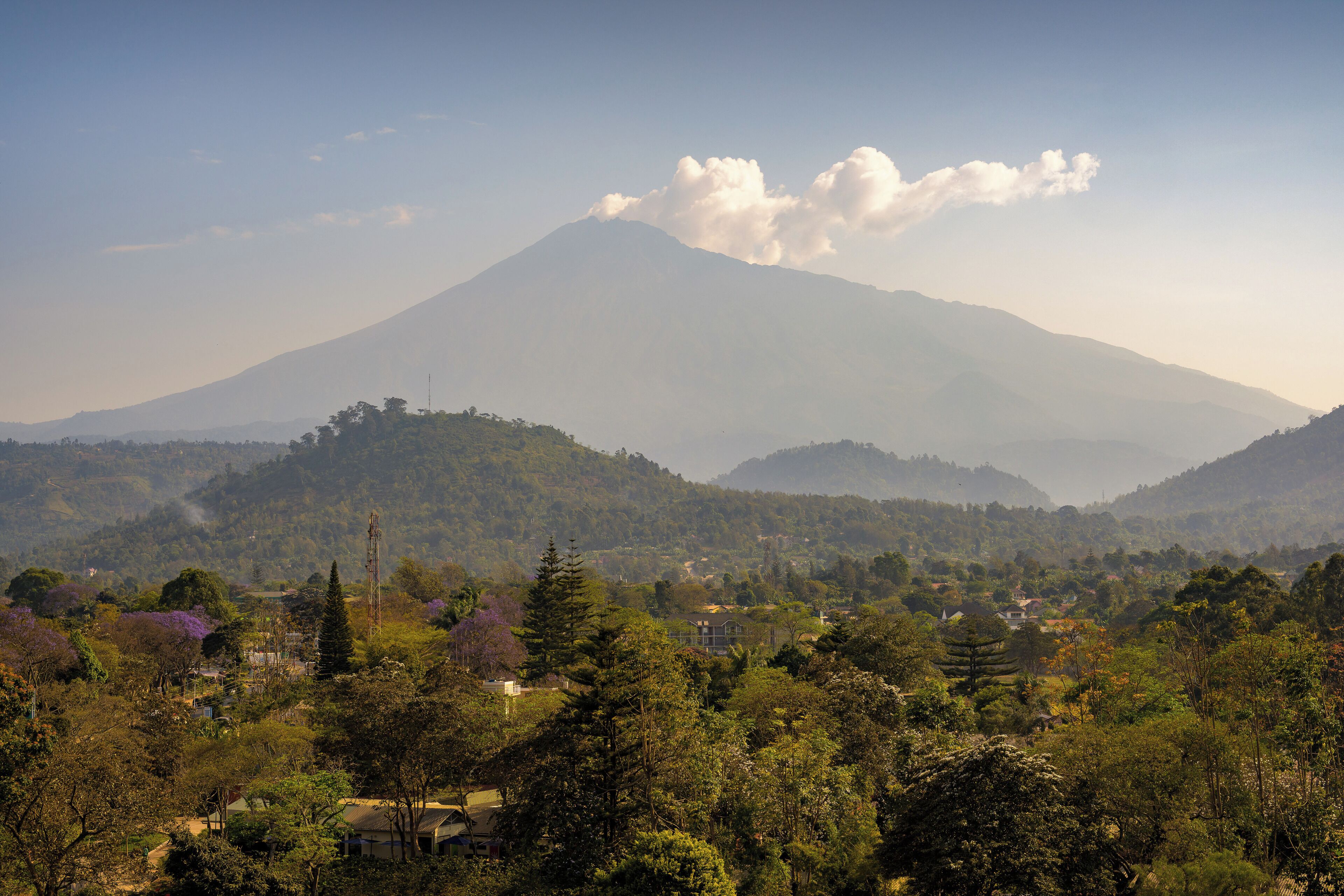 A mountain with a clear sky and a few clouds.