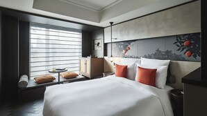 A hotel room with a large bed, a window with blinds, a bedside table, and a headboard with a decorative panel. - Dhawa Yura Kyoto (Kyoto)