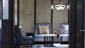 A modern lobby with two seating areas, a chandelier, and a small table. - Dhawa Yura Kyoto (Kyoto)