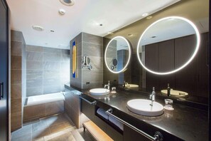 A modern bathroom with two sinks, a bathtub, and a large mirror with circular lights. - Dhawa Yura Kyoto (Kyoto)