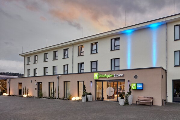 A Holiday Inn Express building with a flat facade, multiple windows, and a welcoming entrance.