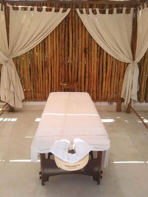 A room with a bed, wooden slats, and curtains.
