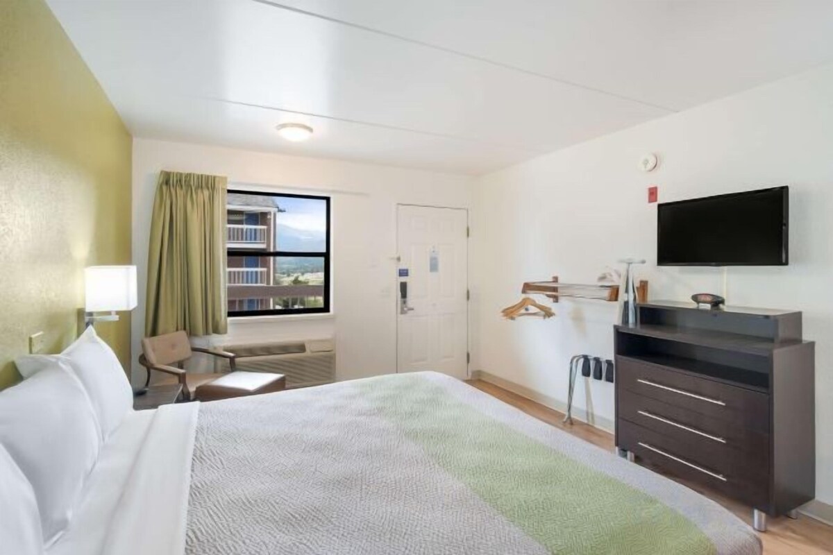 Desk, laptop workspace, blackout drapes, iron/ironing board