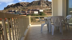 A balcony with a view of a mountainous landscape and a row of houses. - Boa Vista Holidays (Boa Vista)