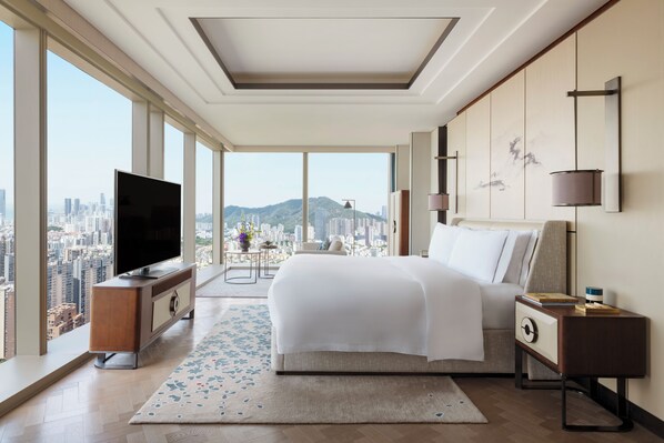A modern hotel room with a large bed, a TV, and a city view. - Raffles Shenzhen (Shenzhen)