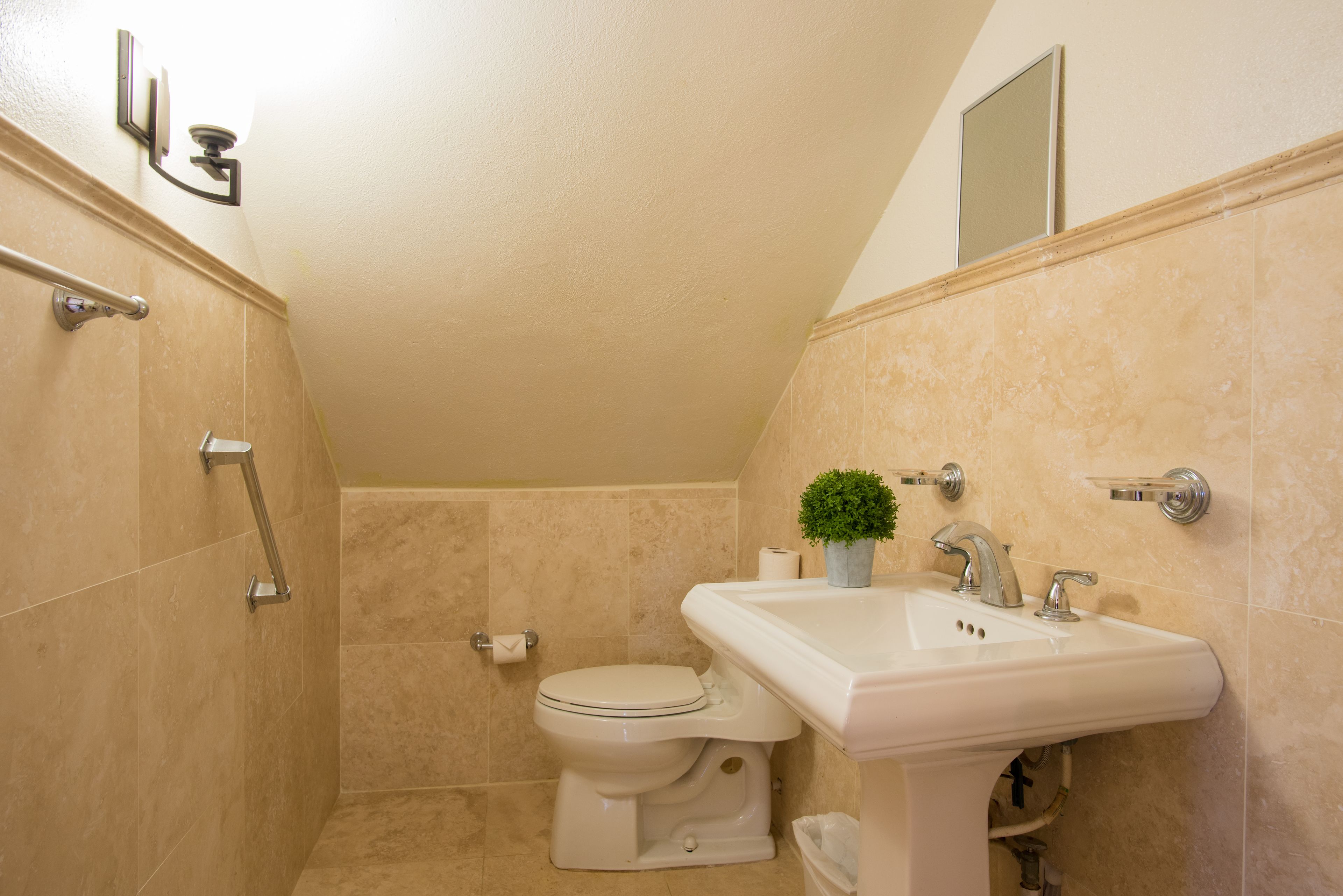 A bathroom with a toilet, sink, and shower area.