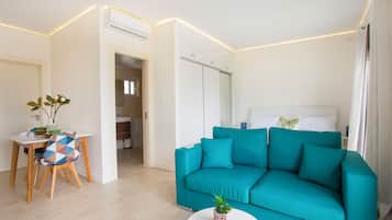 Premium Condo, 1 King Bed, Partial Ocean View, Poolside | In-room safe, soundproofing, iron/ironing board, free WiFi