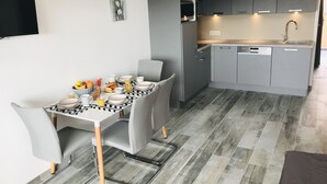 A modern kitchen with grey cabinets, a built-in oven, and a dishwasher. - Apartment renovated, air conditioning, sea view, swimming pools, tennis (Antibes)