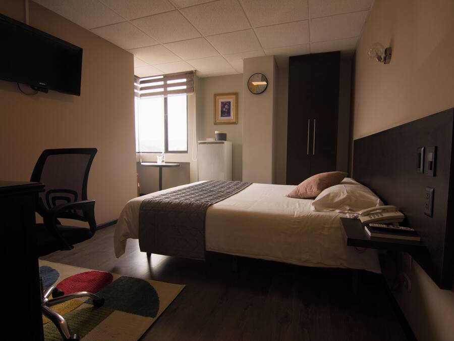 Premium bedding, desk, laptop workspace, blackout drapes