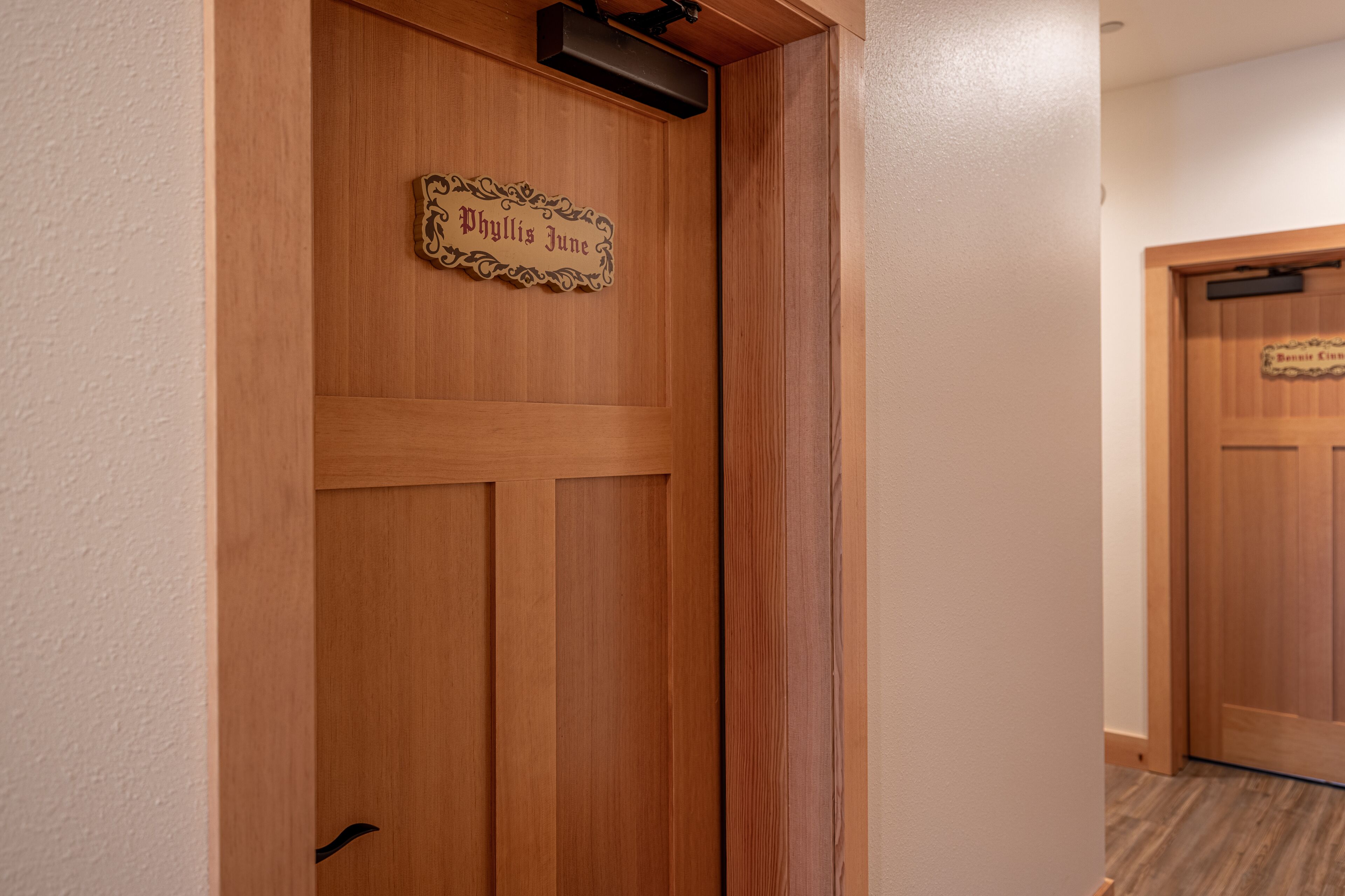 A wooden door with a plaque reading "Phyllis June."