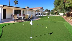 A residential property with a well-maintained lawn, a patio with outdoor furniture, and a house with a red-tiled roof. - Fairview (Scottsdale)