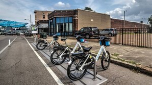 Un espace de stationnement où plusieurs vélos sont garés dans un support à vélos prévu à cet effet.