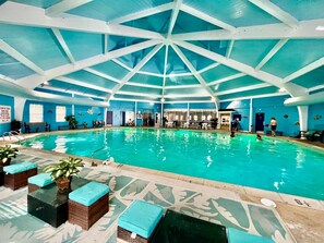 An indoor swimming pool with a high ceiling and blue walls. - Large Pocono Home w/ Hot Tub & Game Room: Near Ski Slopes, Lakes & Water Parks (Long Pond)