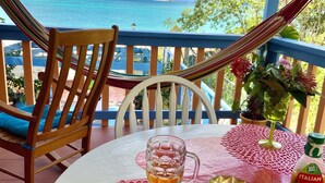 A table with a plate of grilled chicken, a glass of beer, and a bottle of Italian dressing. - Just in-November dates have just become available  (L’Esterre)