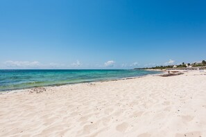 On the beach, sun-loungers