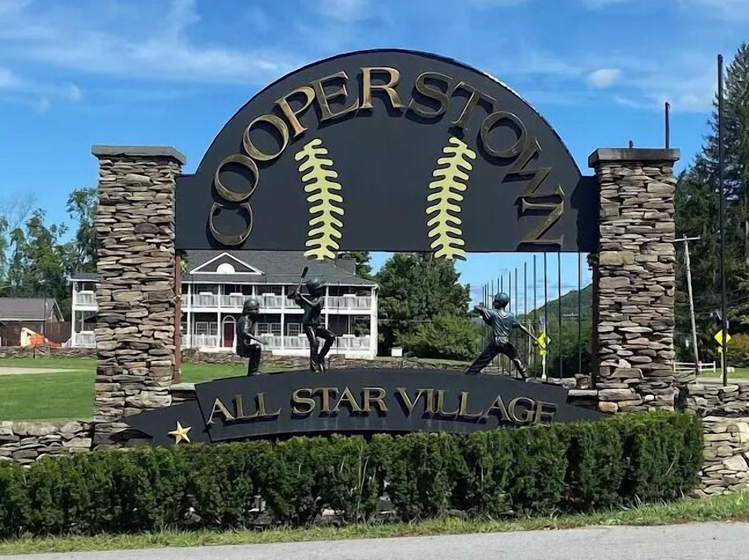 A sign for Cooperstown with baseball imagery and the text 'All Star Village.'