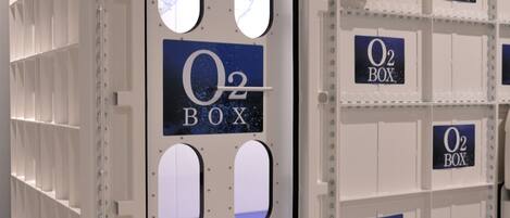 A storage area with multiple O2 BOXes labeled on the walls and doors.