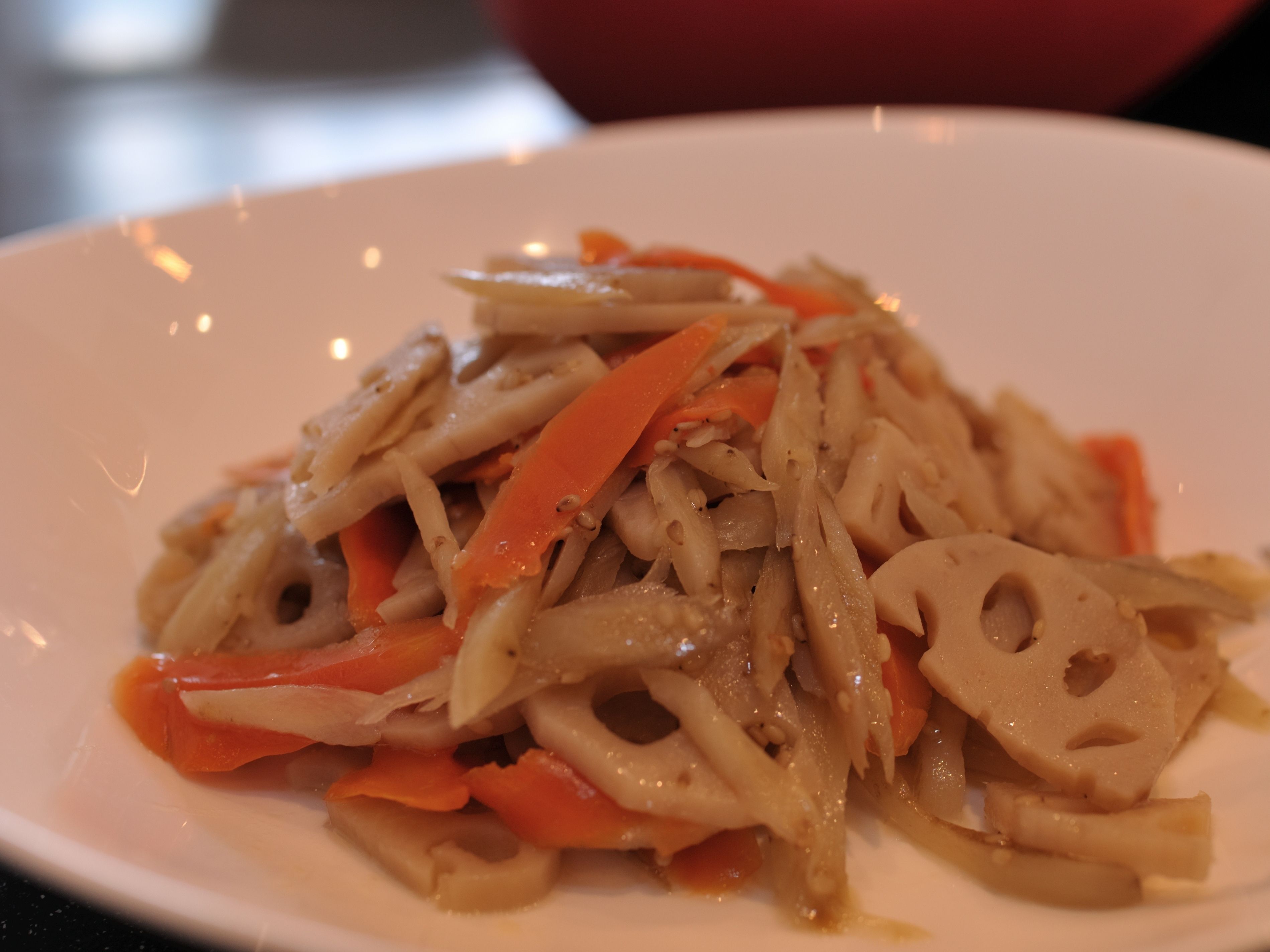 A plate of stir-fried vegetables with carrots and mushrooms.