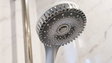 A showerhead with a circular design and multiple nozzles.