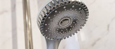 A showerhead with a circular design and multiple nozzles.