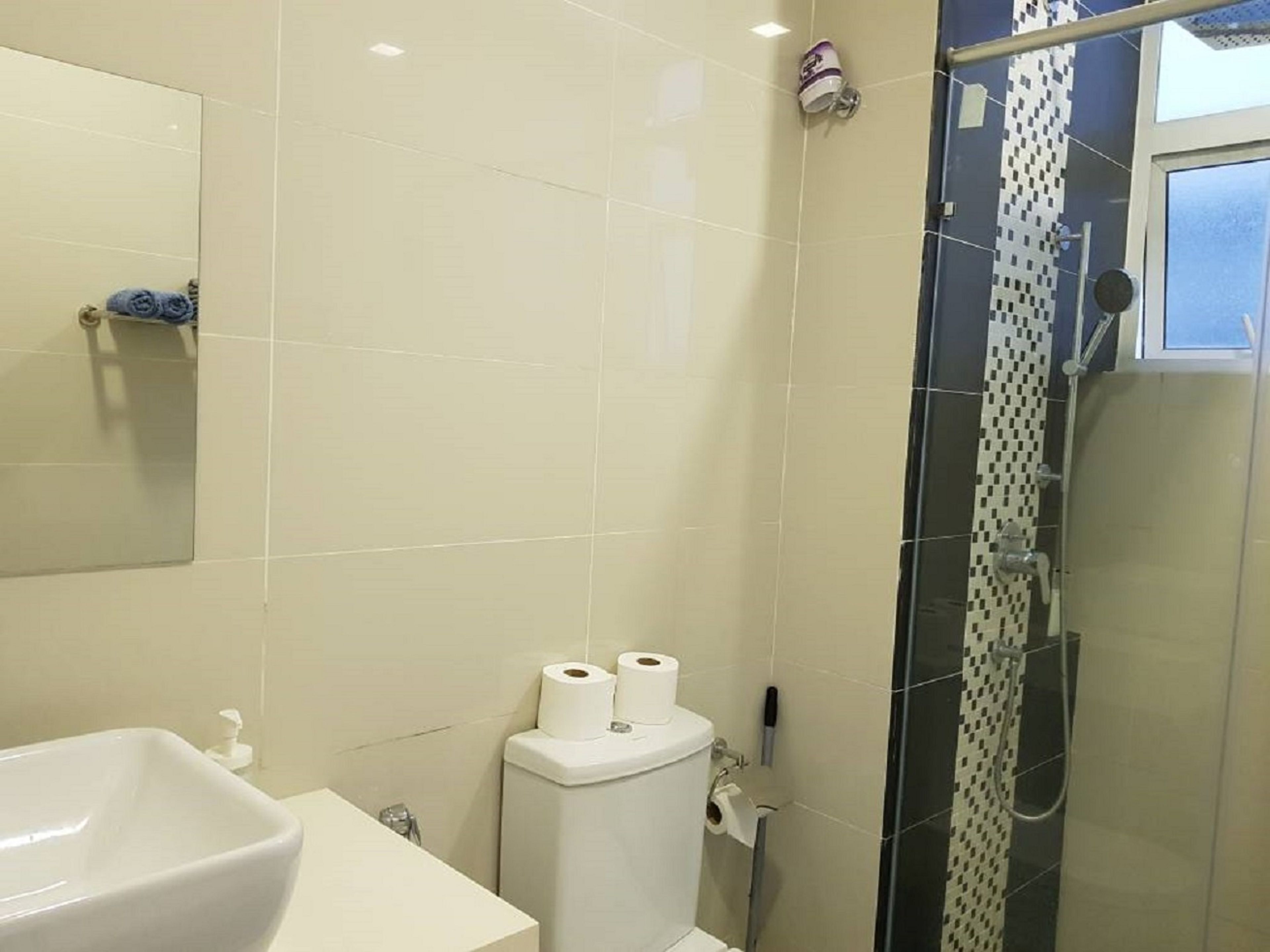 A bathroom with a sink, toilet, and shower.