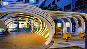 A modern architectural structure with a wooden deck and a series of white arches. - Skypod Residence (Puchong)