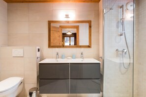 Shower, hair dryer, towels, toilet paper