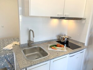 Fridge, microwave, stovetop, coffee/tea maker
