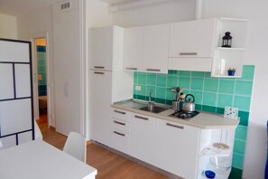 A compact kitchen with white cabinets, a sink, and a countertop. - S127 - Sirolo, brand new studio with terrace (Sirolo)