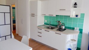 A compact kitchen with white cabinets, a sink, and a countertop. - S127 - Sirolo, brand new studio with terrace (Sirolo)
