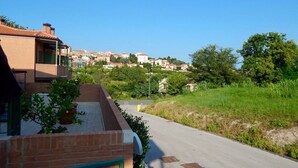 A residential street with houses, a clear sky, and greenery. - S127 - Sirolo, brand new studio with terrace (Sirolo)