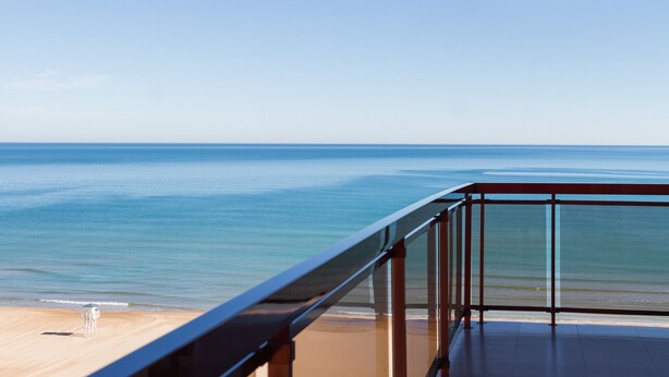 A balcony with a clear view of the beach and ocean. - LUXURY APARTMENT APARTMENT 11 with direct views of the sea, sunrises live. (GANDIA PLAYA)